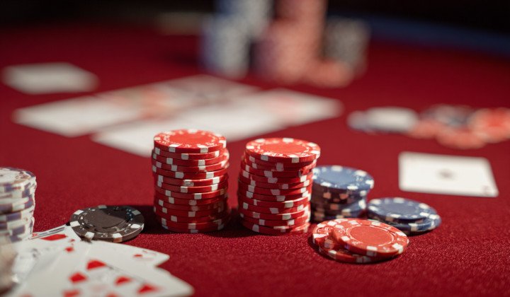 Roulette chips and playing cards on a table in casino